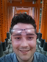 Myself, standing under the shrines built on Mt. Inari in Kyoto, Japan in the summer of 2015